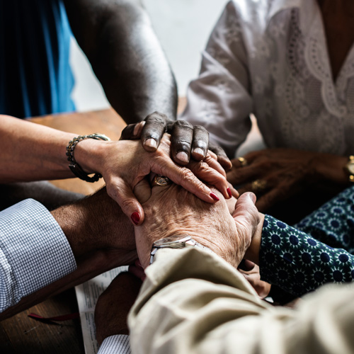 diverse hands stacked together symbolizing unity and teamwork building strong connections in a group setting celebrating partnership and collaboration with ten people involved